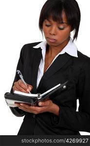 Fed-up businesswoman writing in her agenda