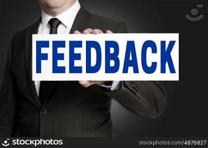 feedback sign is held by businessman background. feedback sign is held by businessman background.