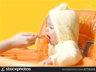 feeding cute baby boy isolated on white background