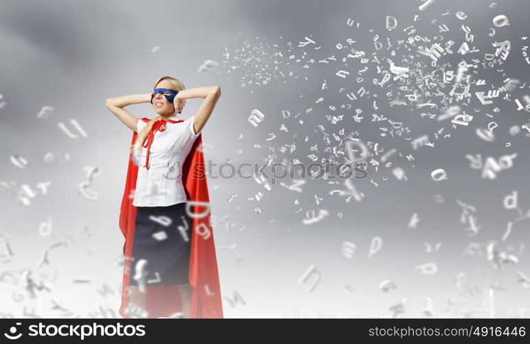 Feel yourself a hero!. Young confident woman in super hero costume