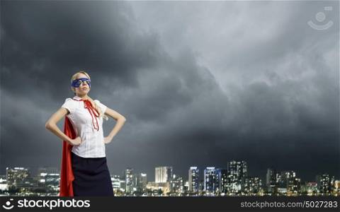 Feel yourself a hero!. Young confident woman in super hero costume
