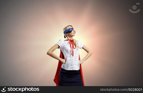 Feel yourself a hero!. Young confident woman in super hero costume