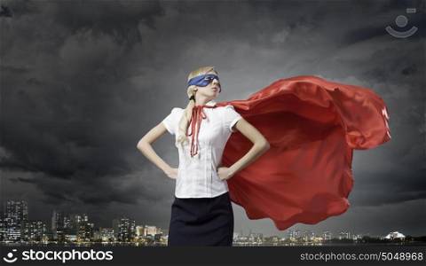 Feel yourself a hero!. Young confident woman in super hero costume