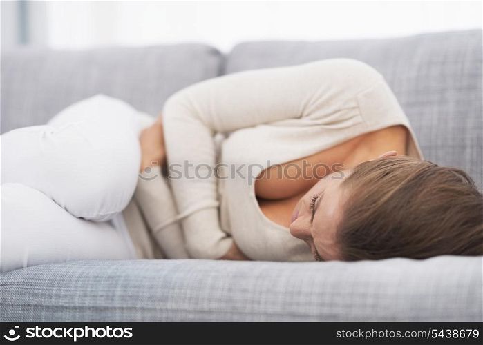 Feeling bad young woman laying on sofa
