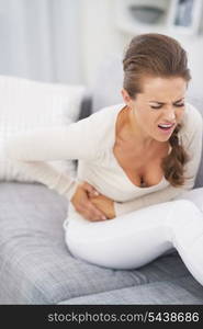 Feeling bad young woman sitting on sofa