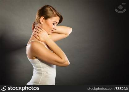 Feeling exhausted, back and spine disease. Woman having bad ache. Female placing hands on her neck suffering from pain. Woman suffering from neck pain