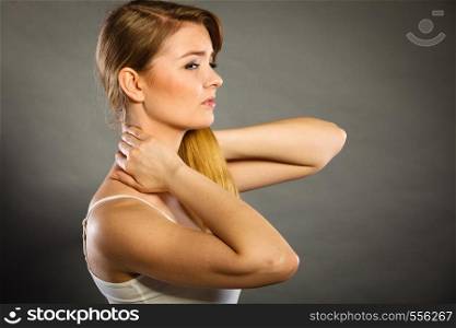 Feeling exhausted, back and spine disease. Woman having bad ache. Female placing hands on her neck suffering from pain. Woman suffering from neck pain