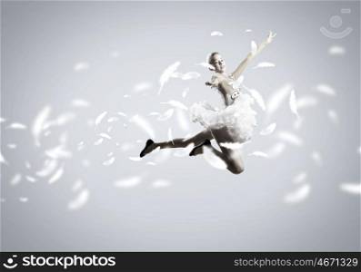 Feeling of lightness. Young pretty ballerina girl making jump in dance