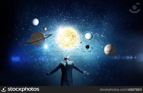 Feeling power. Young businessman and planets of space spinning around