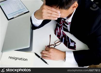 Feeling sick and tired. Frustrated middle aged businessman sitting at office desk