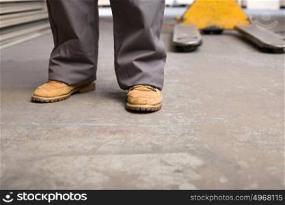 Feet and legs of a person in warehouse
