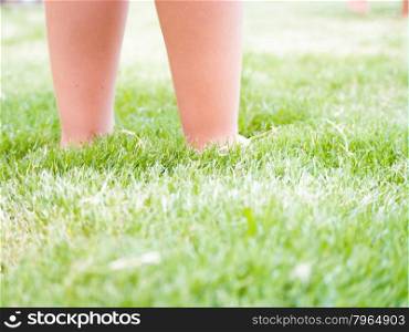 Feet Kid on the grass. feet of a child sinking in the grass. Concept of Freedom