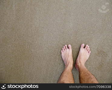 Feet of Asian male on the beach