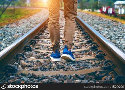 Feet of male walking on railroad. Travel concept.