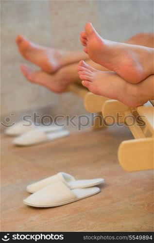 Feet of two women relaxing at beauty spa room