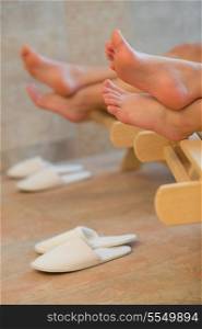 Feet of two women relaxing at beauty spa room