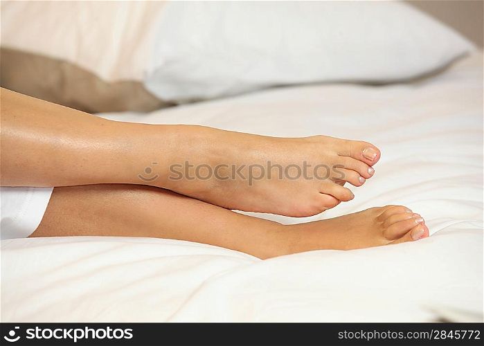 Feet on a bed