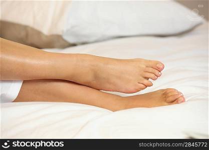 Feet on a bed