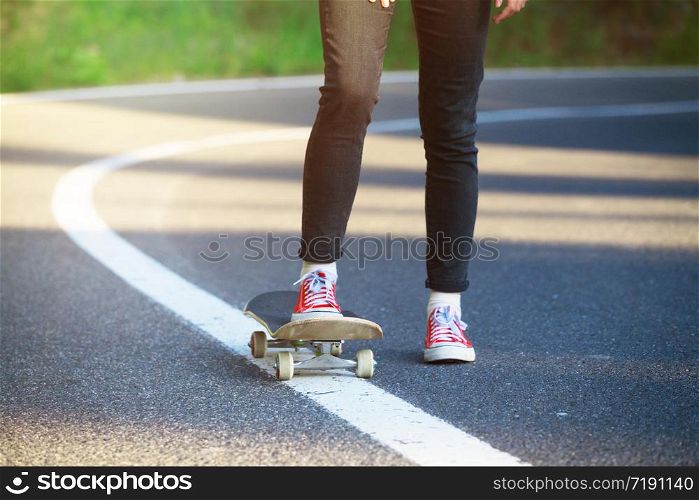 feet on a skateboard. girl rides on a skateboard at the transalpine. Romania.