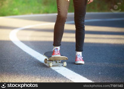 feet on a skateboard. girl rides on a skateboard at the transalpine. Romania.