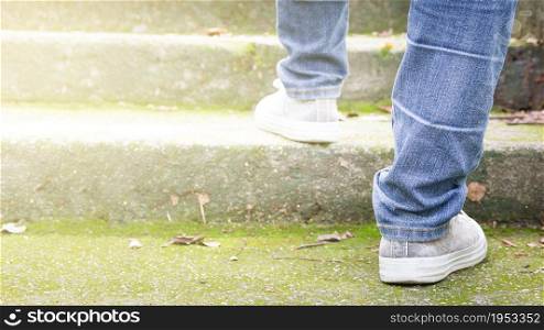 Feet Sneakers And Jeans Walking On Staircase Outdoor With Autumn Season Nature On Background Lifestyle Fashion Trendy Style, Walking In The Park Outdoors.
