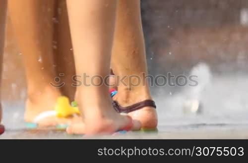 feet splashing in the fountain