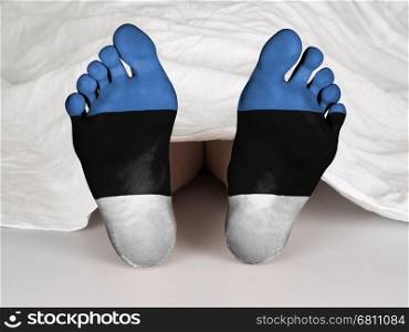 Feet with flag, sleeping or death concept, flag of Estonia