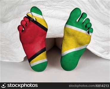 Feet with flag, sleeping or death concept, flag of Guyana