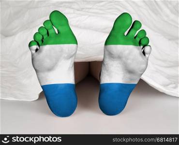Feet with flag, sleeping or death concept, flag of Siera Leone