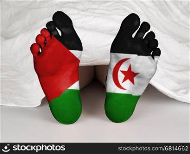 Feet with flag, sleeping or death concept, flag of Western Sahara