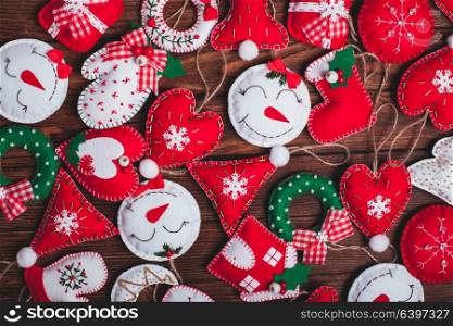 felt Christmas decorations on the wooden table as a background. felt Christmas decorations