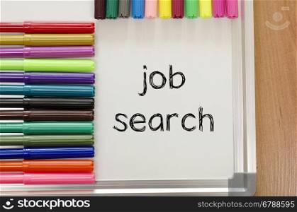 Felt-tip pen and whiteboard on a wooden background and job search text concept