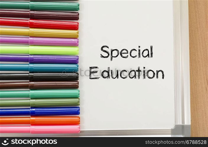 Felt-tip pen and whiteboard on a wooden background and special education text concept