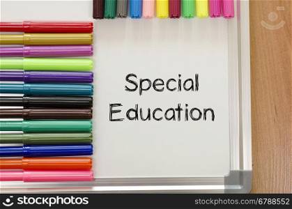 Felt-tip pen and whiteboard on a wooden background and special education text concept