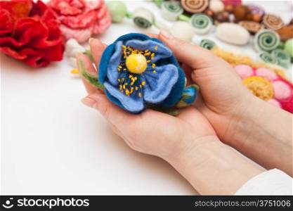 Felting activity - felted flower in woman&#39;s hands