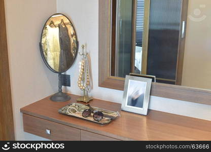 female accessories on wooden dressing table at home