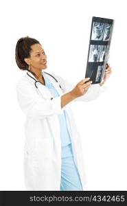 Female, african-american doctor looks at films from a CT scan. Isolated on white.