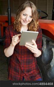 Female Agricultural Worker On Farm Using Digital Tablet