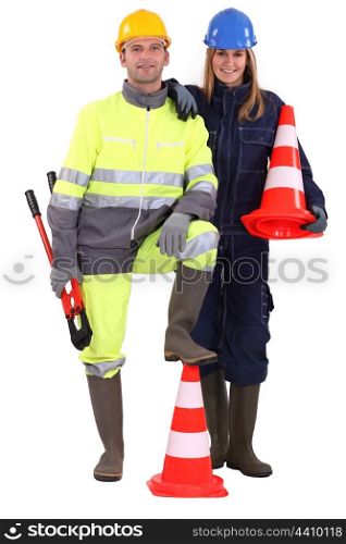 female and male road workers posing together