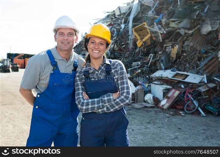 female and male worker on junkyard
