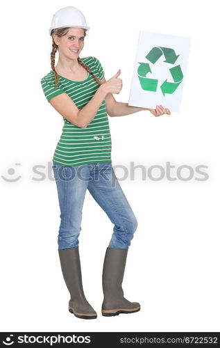 female apprentice holding recycling logo