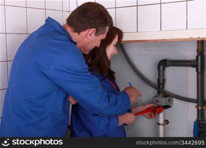 female apprentice plumber and male instructor