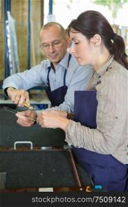 female apprentice using cutter in carpentry workshop