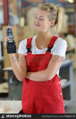 female apprentice working on drill in factory