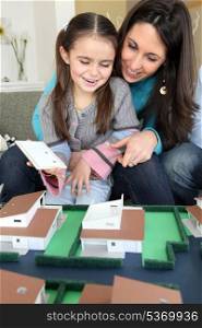 female architect at home with young daughter