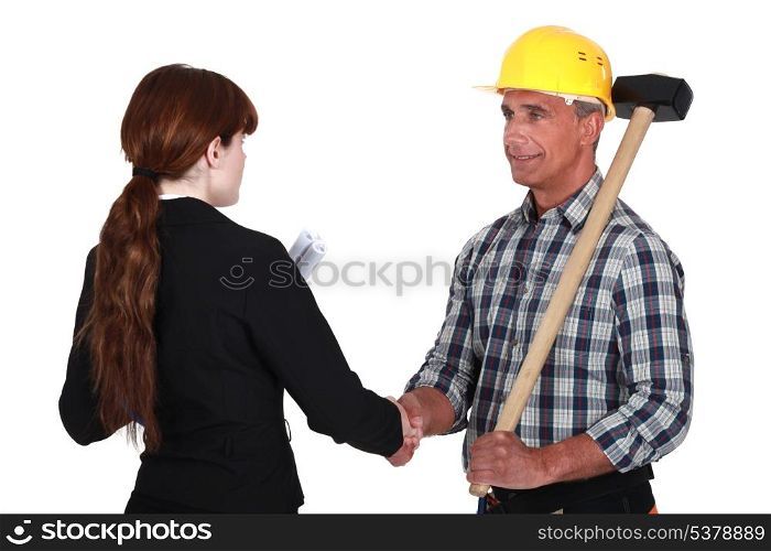 Female architect greeting builder