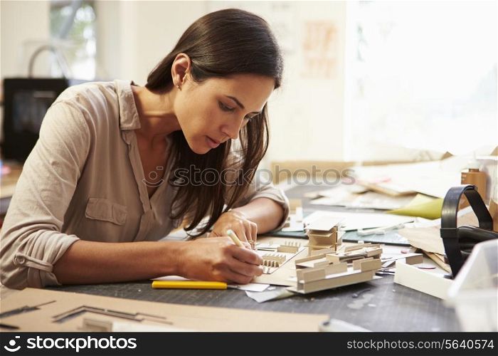 Female Architect Making Model In Office
