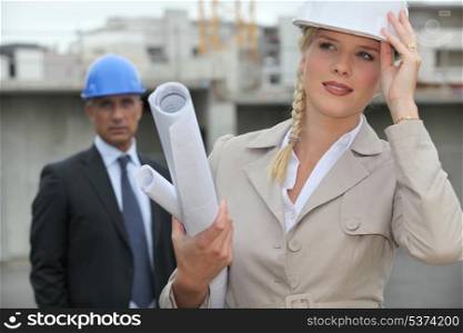Female architect on site holding her hard hat