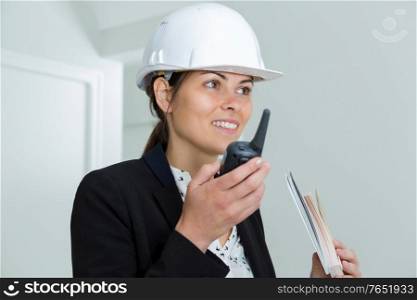 female architect talking on a walkie- talkie