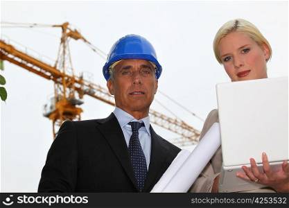female architect with foreman in construction site